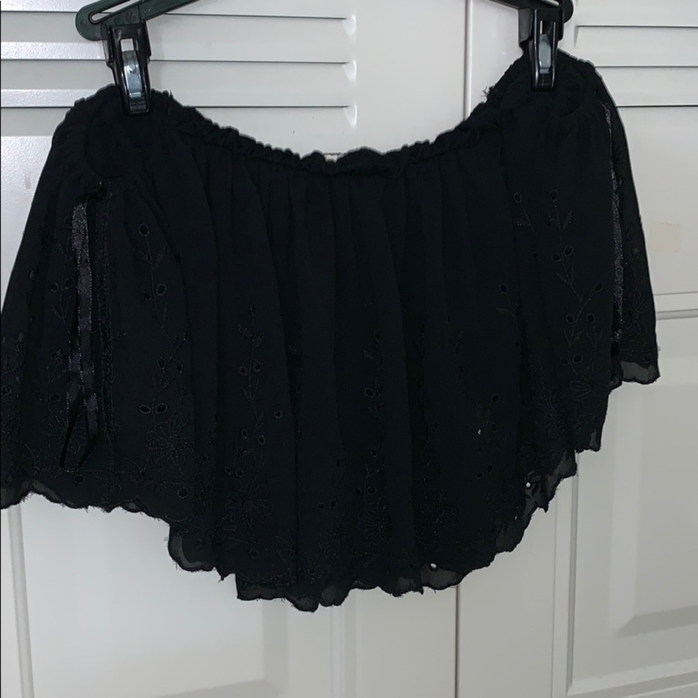 a black off the shoulder black shirt